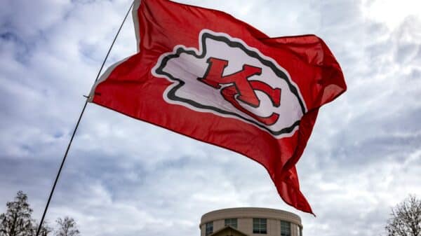 a kansas chiefs flag flying in front of a building