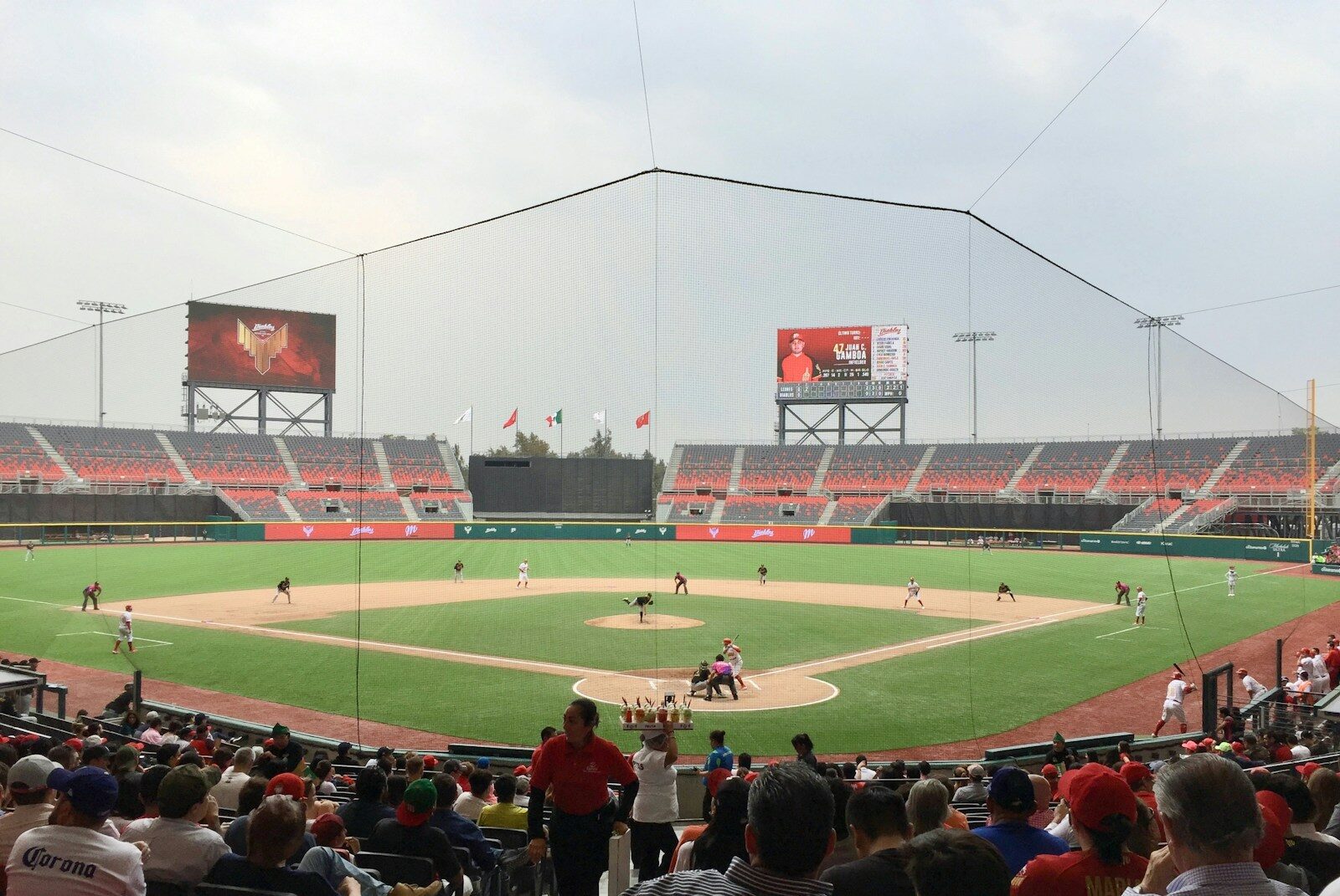 a baseball game is being played on a cloudy day