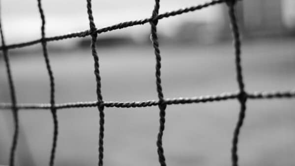 black metal fence in grayscale photography