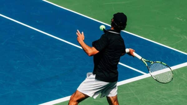 a man holding a tennis racquet on a tennis court
