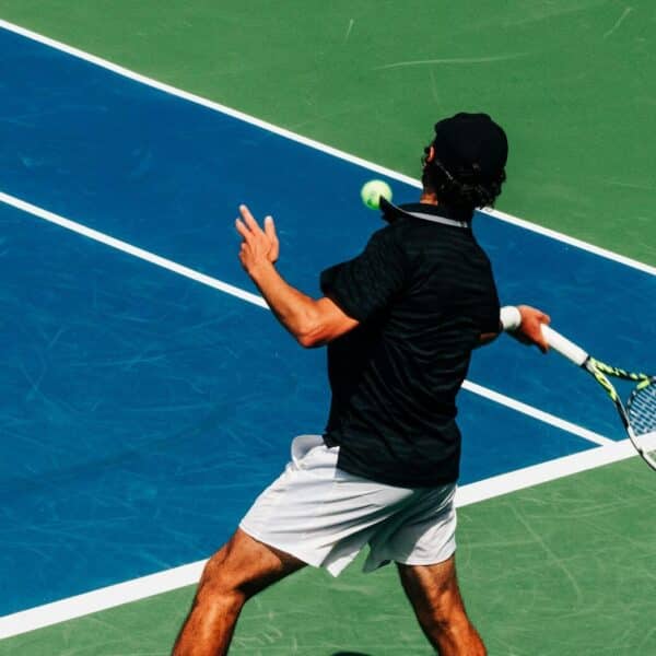 a man holding a tennis racquet on a tennis court