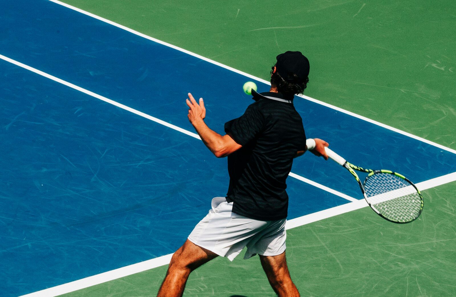 a man holding a tennis racquet on a tennis court