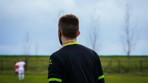 a man standing in a field with a frisbee in his hand